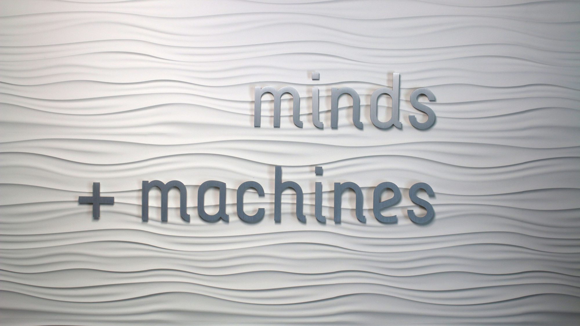 Minds + Machines logo on the office wall
